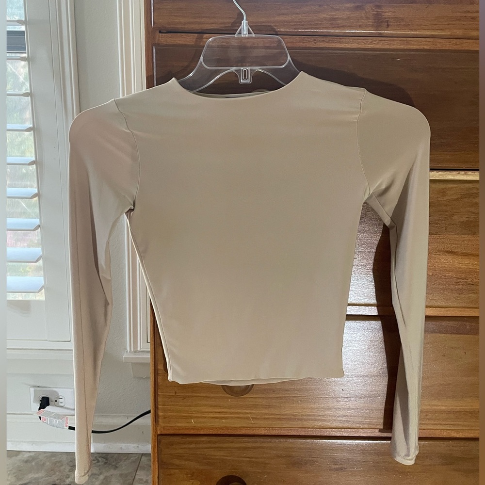 Sheer beige long sleeve top.
